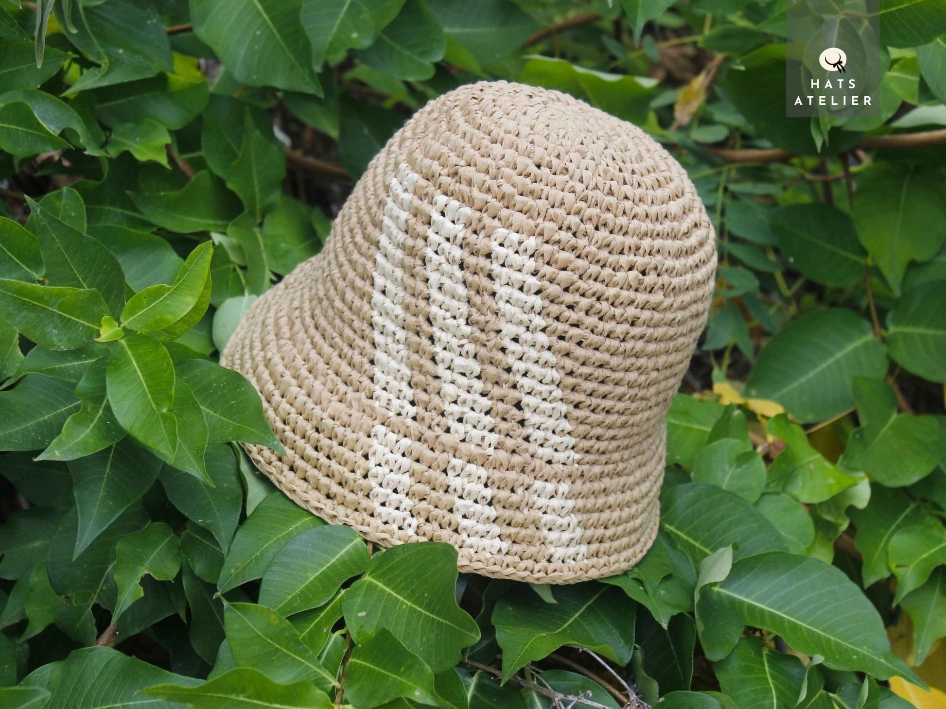 Top view of handwoven crochet raffia bucket hat in natural straw