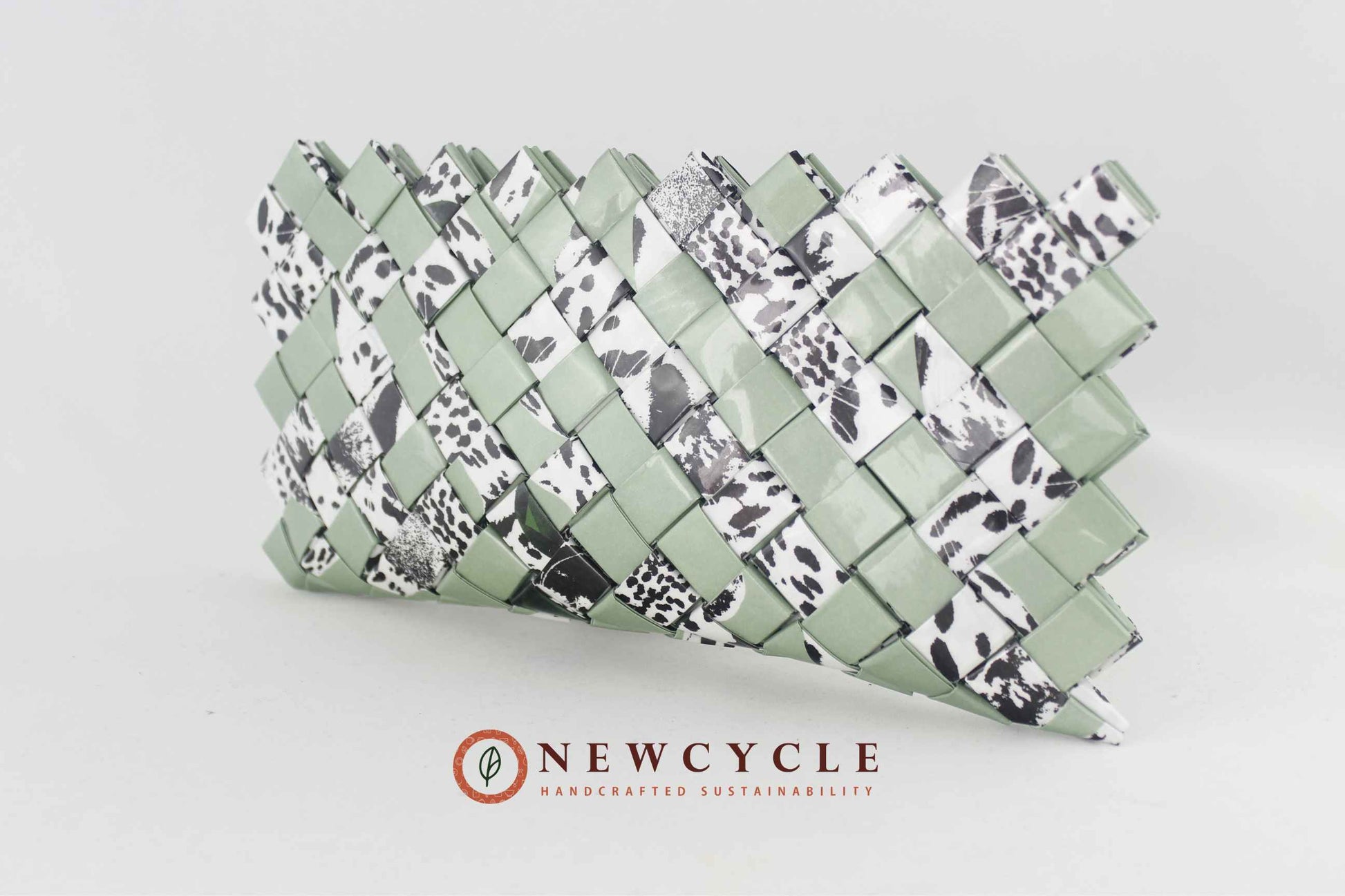 front view sage green woven clutch with black white animal print