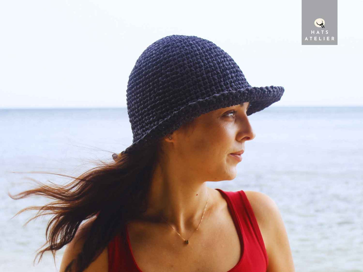Black raffia crochet hat worn outdoors side view