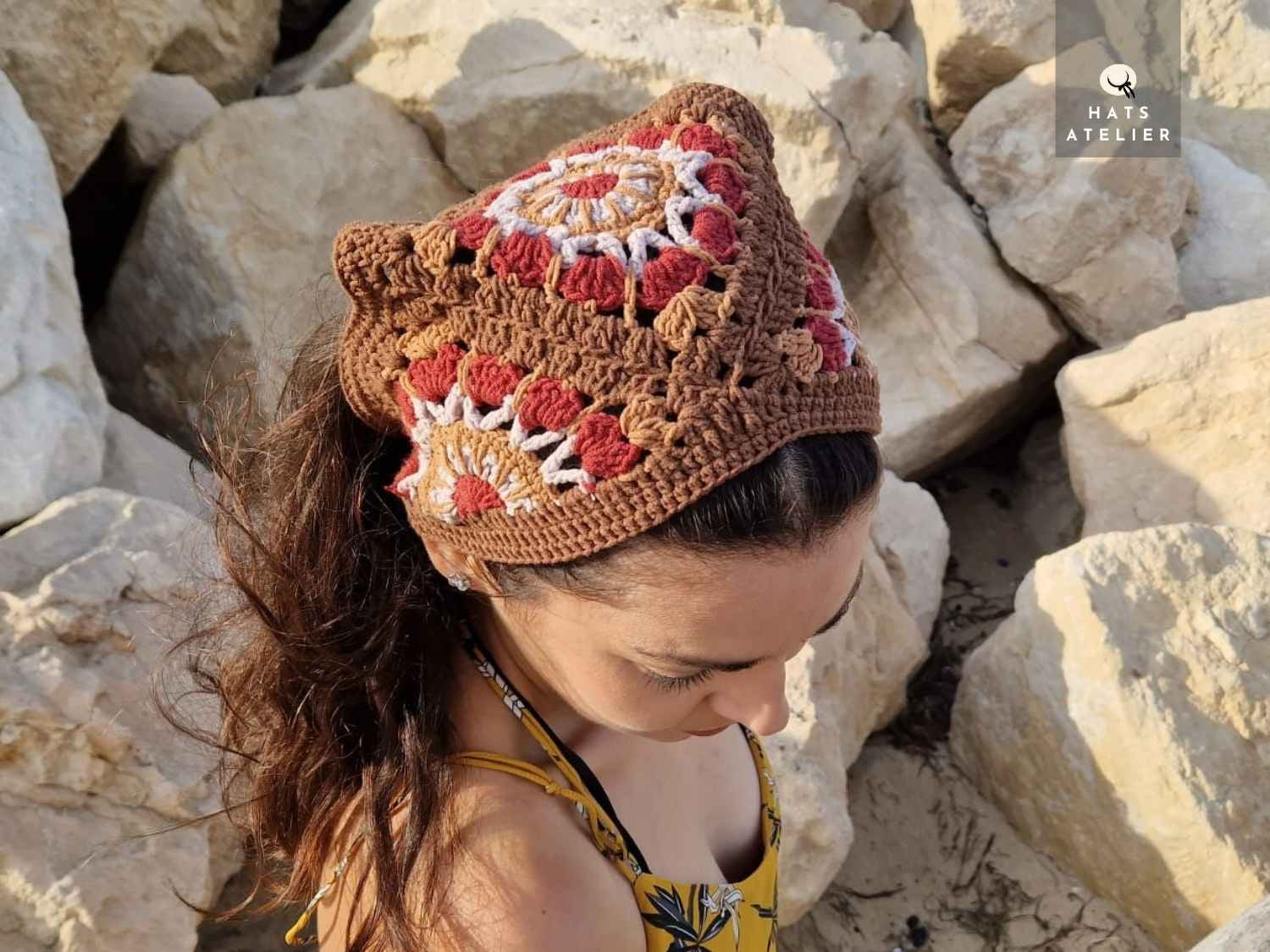 Woman wearing a crocheted bandana on rocky terrain