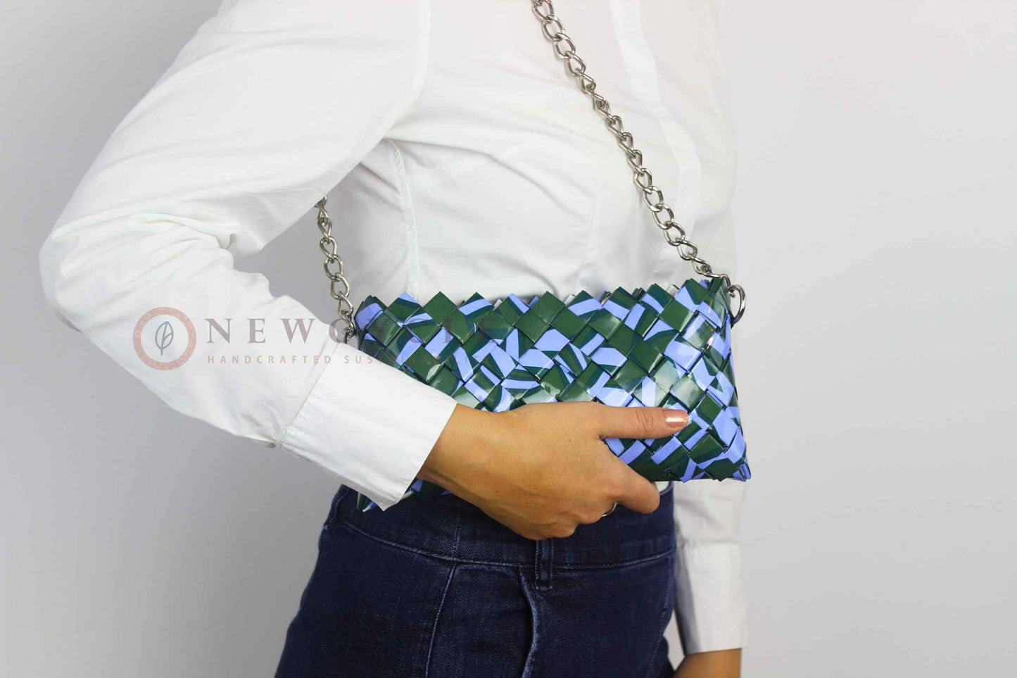 green lilac eco friendly clutch worn on shoulder