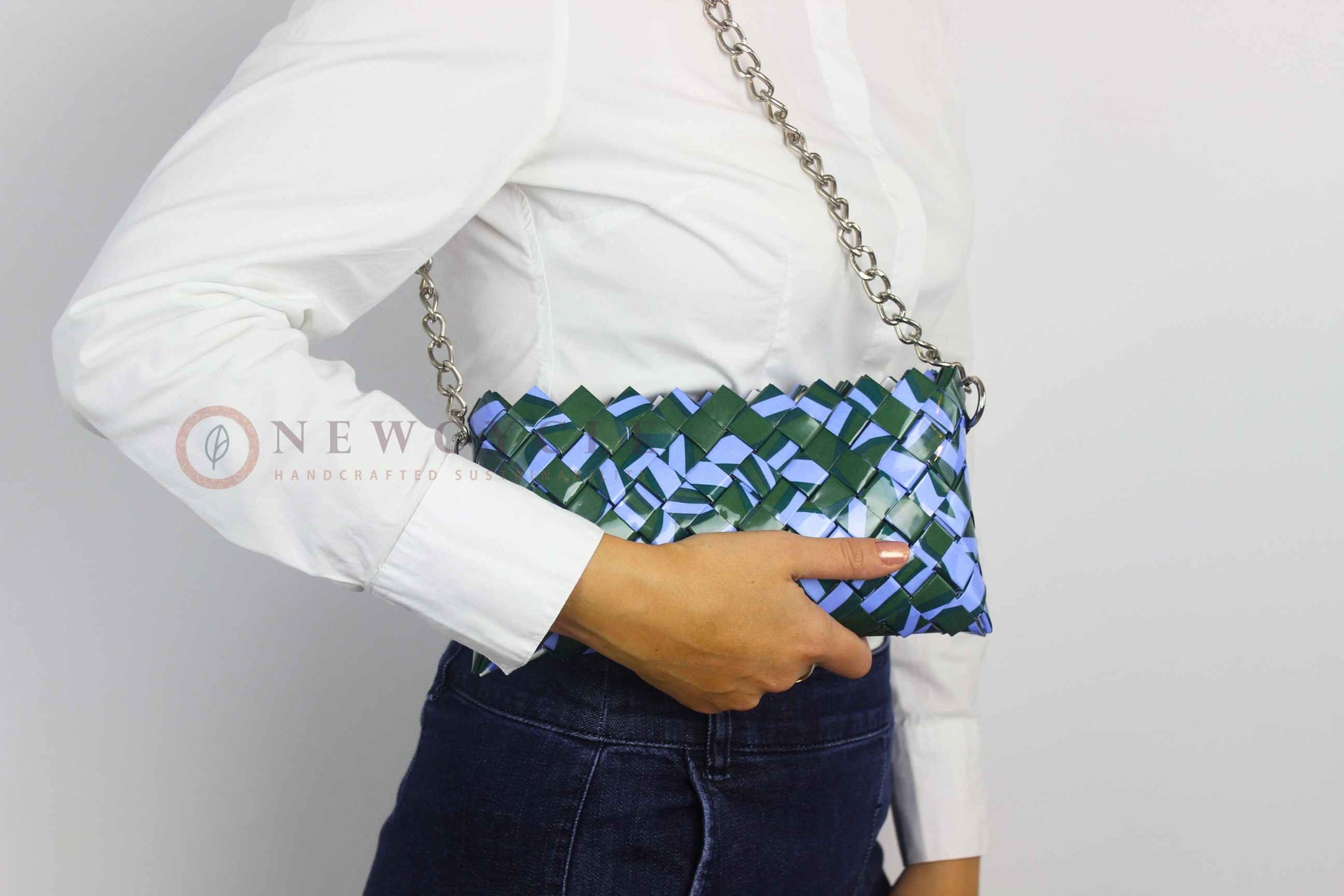 green lilac eco friendly clutch worn on shoulder