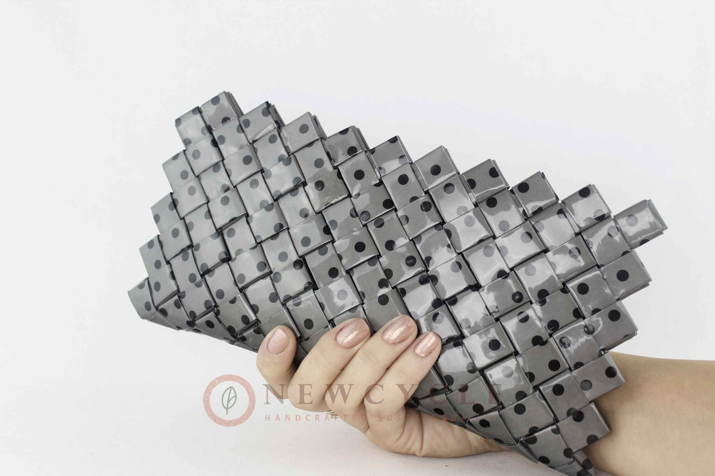 Eco friendly woven clutch in black and grey polka dot pattern