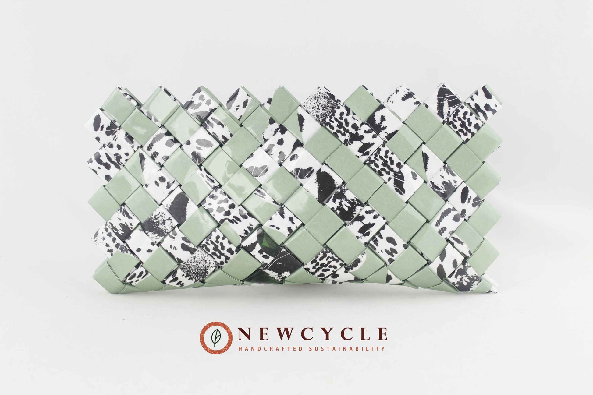 front view sage green woven clutch with black white animal print