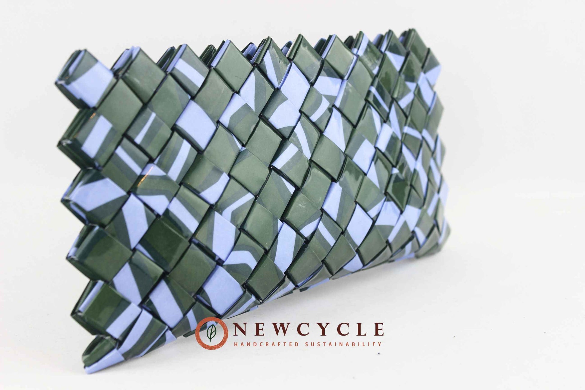 Front view of a handmade upcycled woven clutch in forest green and powder blue with the NEWCYCLE logo.