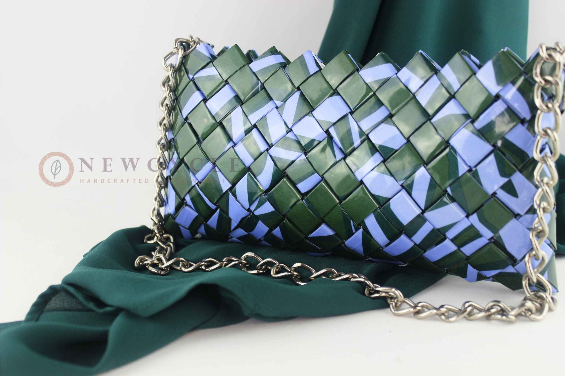 green lilac woven purse displayed on fabric