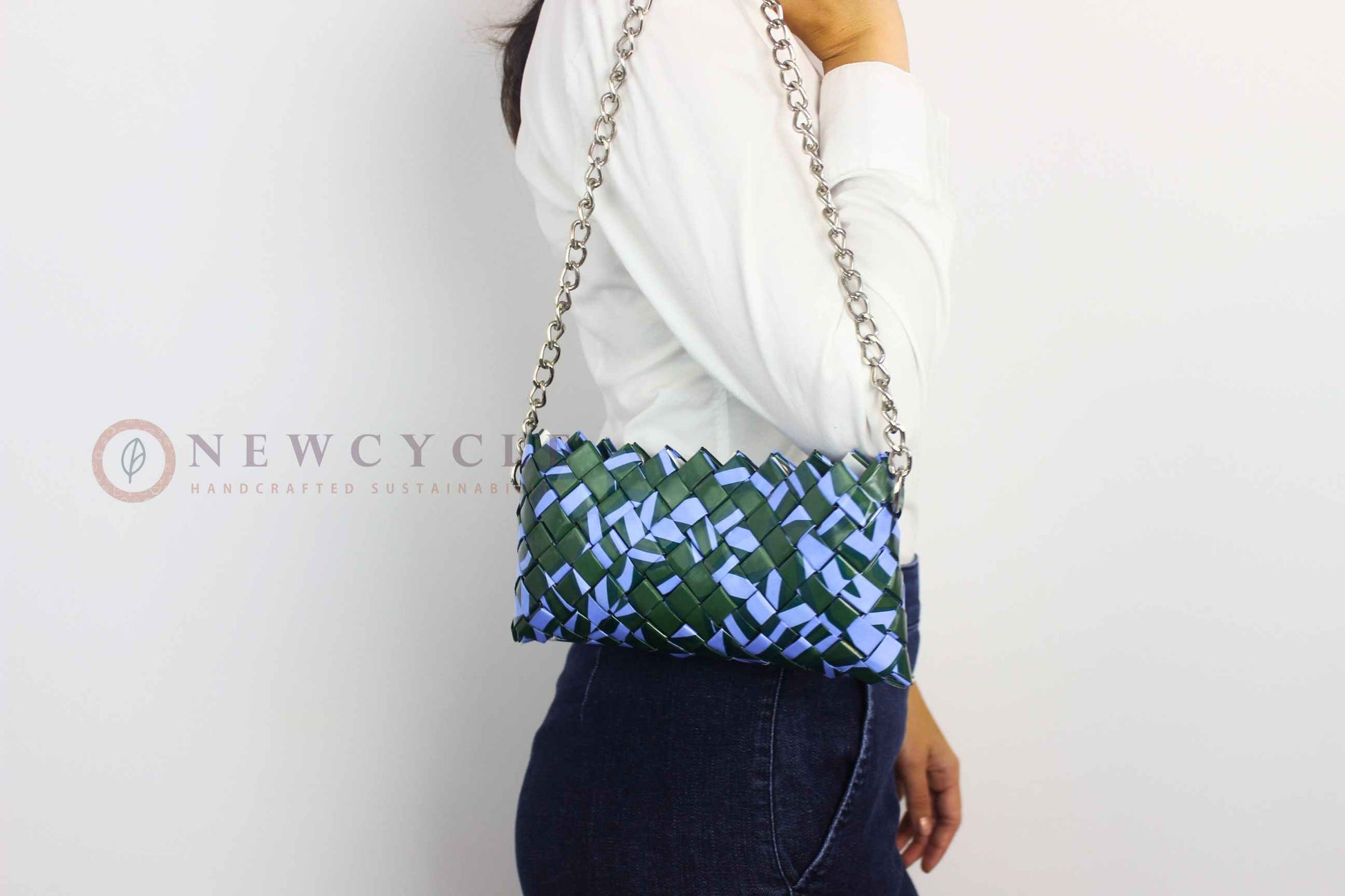model wearing green lilac woven chain purse crossbody