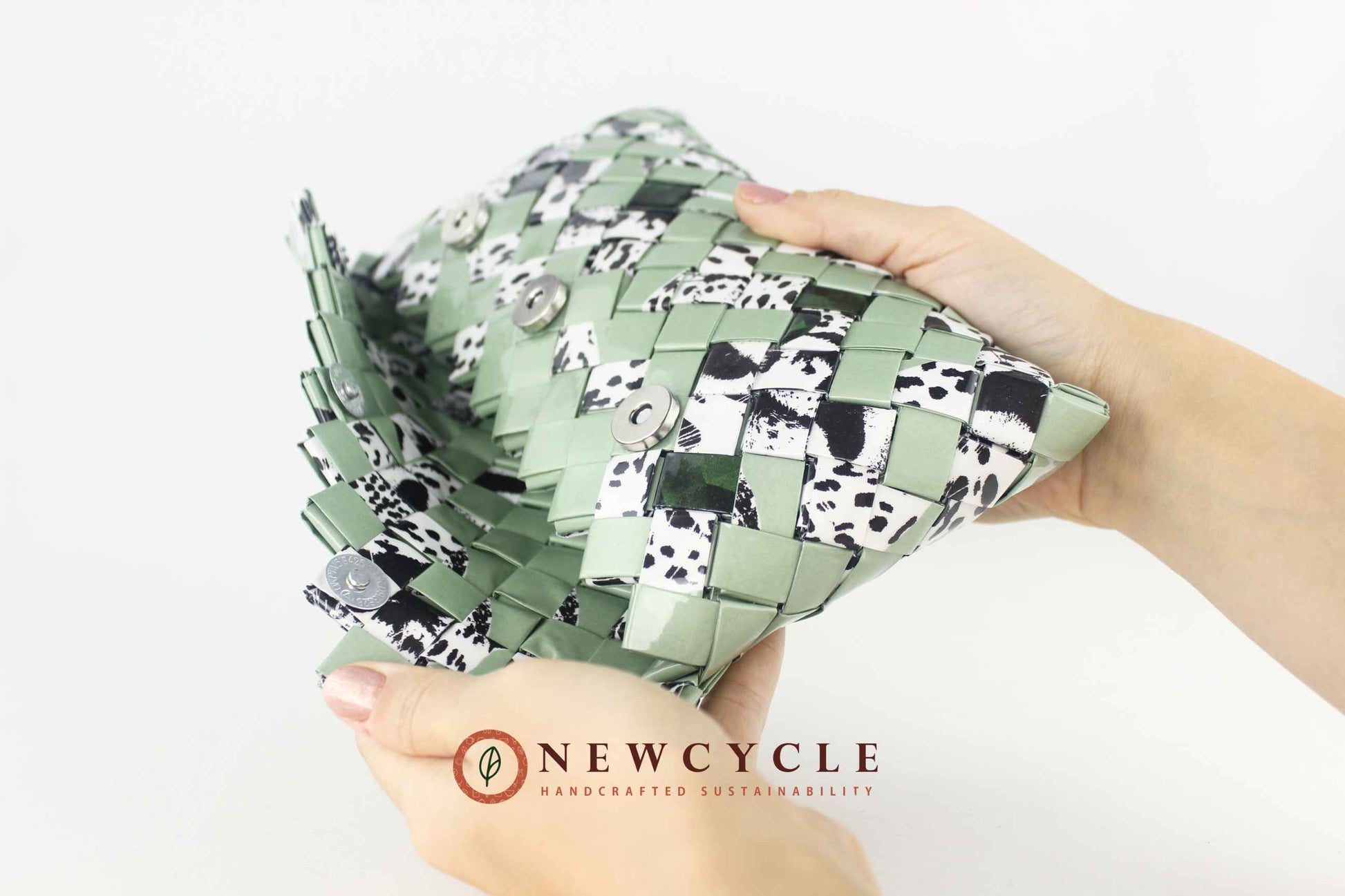 Side angle of green upcycled clutch showing woven texture