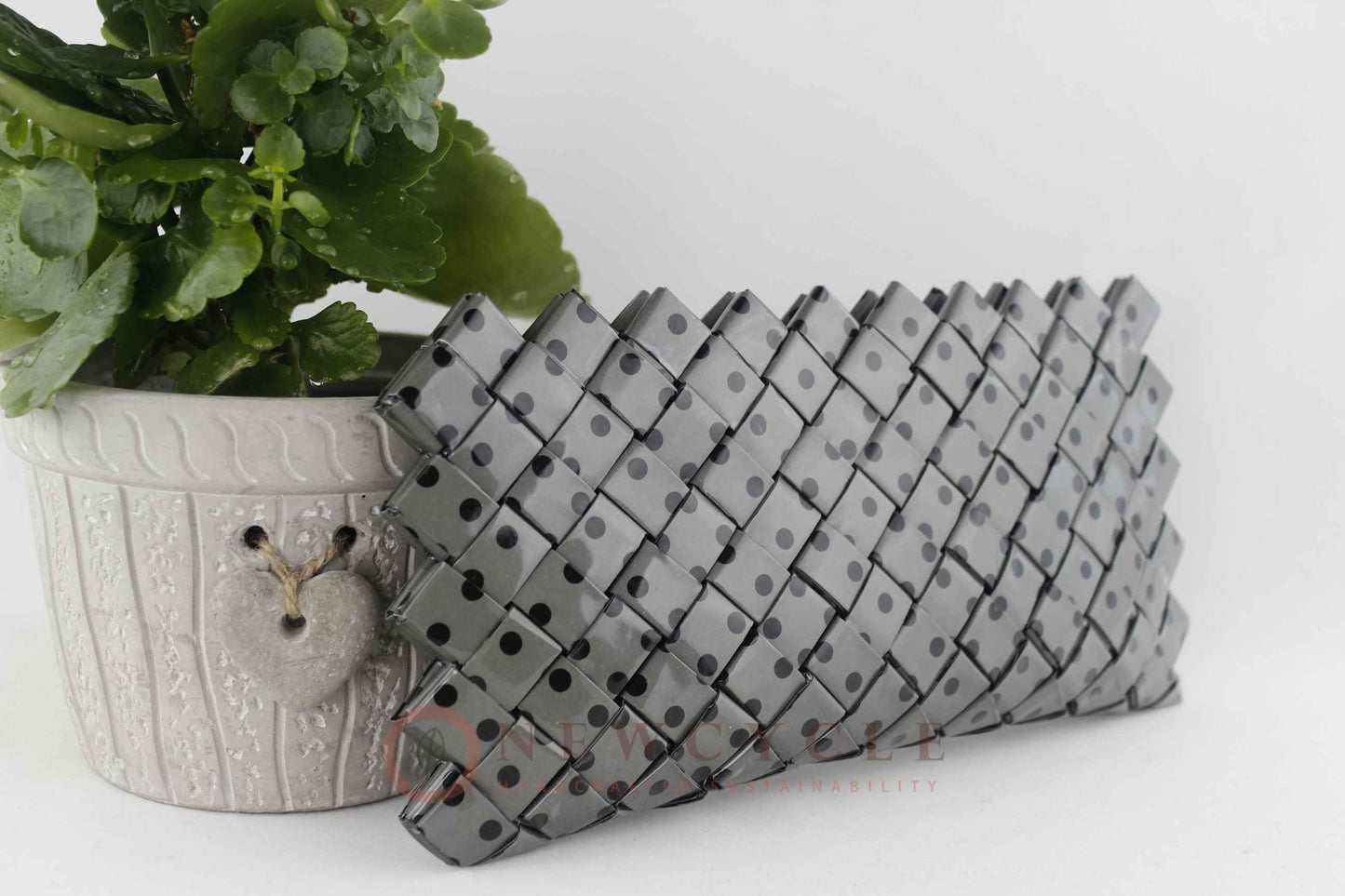 Side interior view of grey polka dot upcycled woven purse