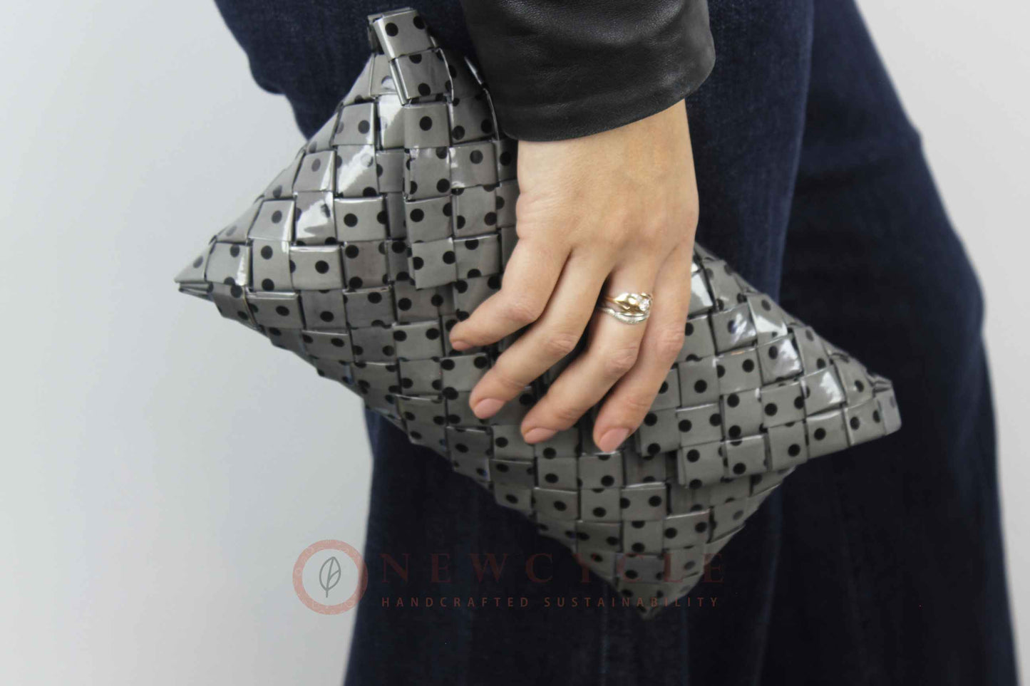 Handmade black and grey polka-dot clutch styled with a modern black outfit