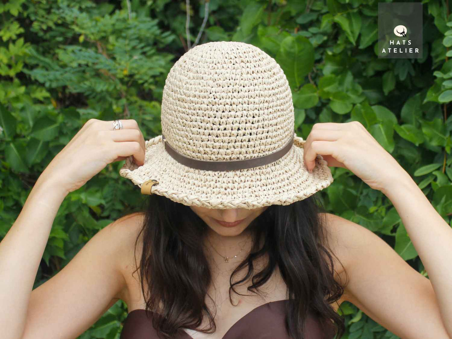 handwoven crochet raffia hat top view on model