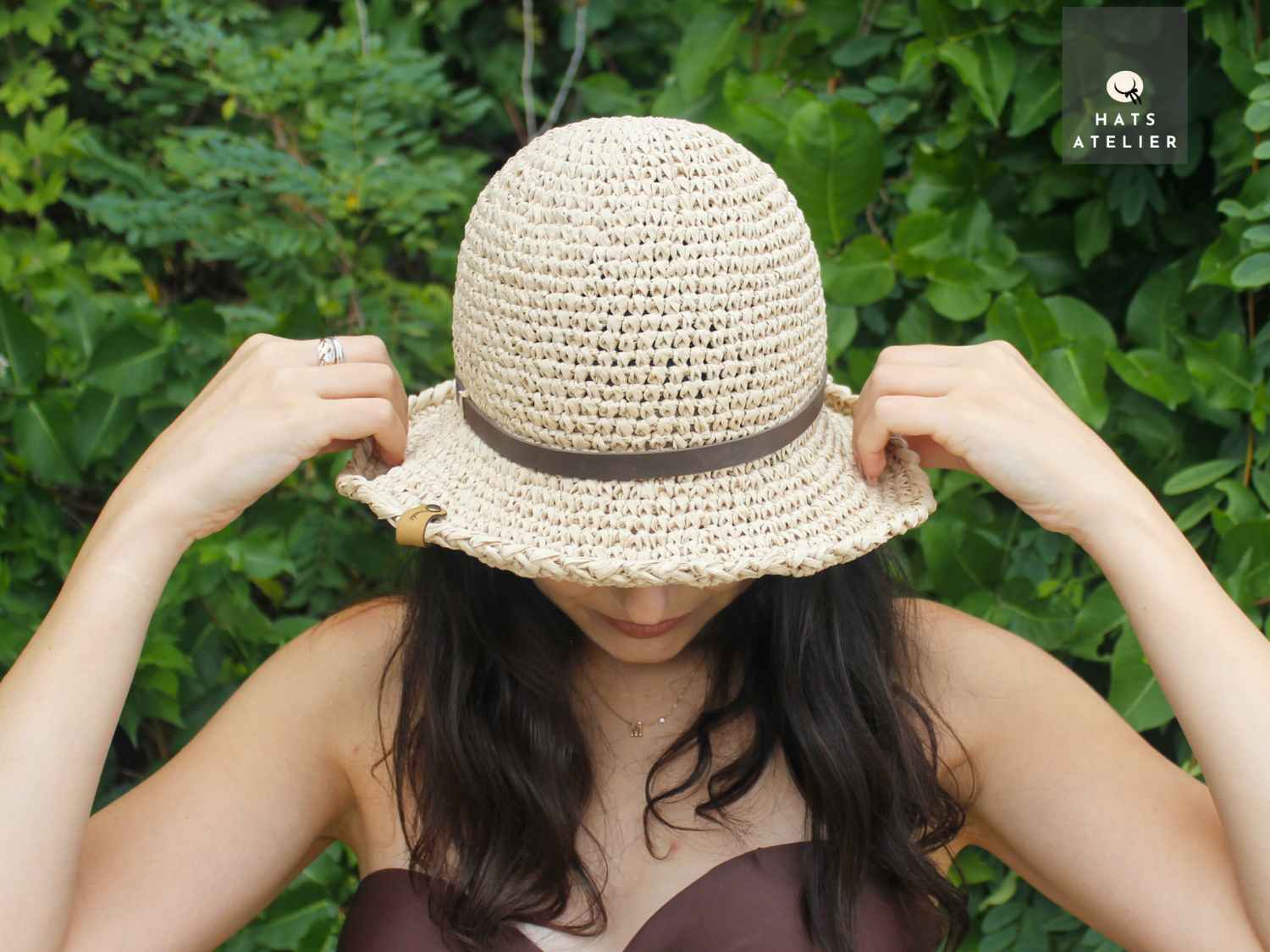 handwoven crochet raffia hat top view on model