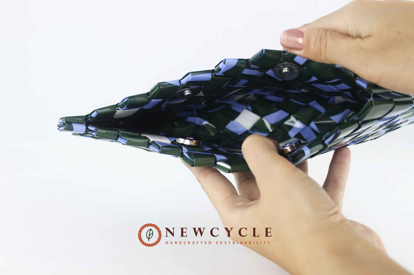 Interior view of the handmade upcycled woven clutch in forest green and powder blue.