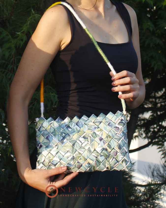 Leaf-pattern handbag held against colorful summer outfit