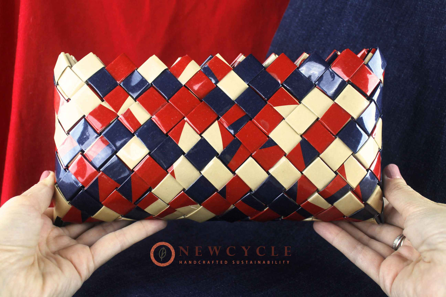 Front view of red navy cream woven mosaic clutch