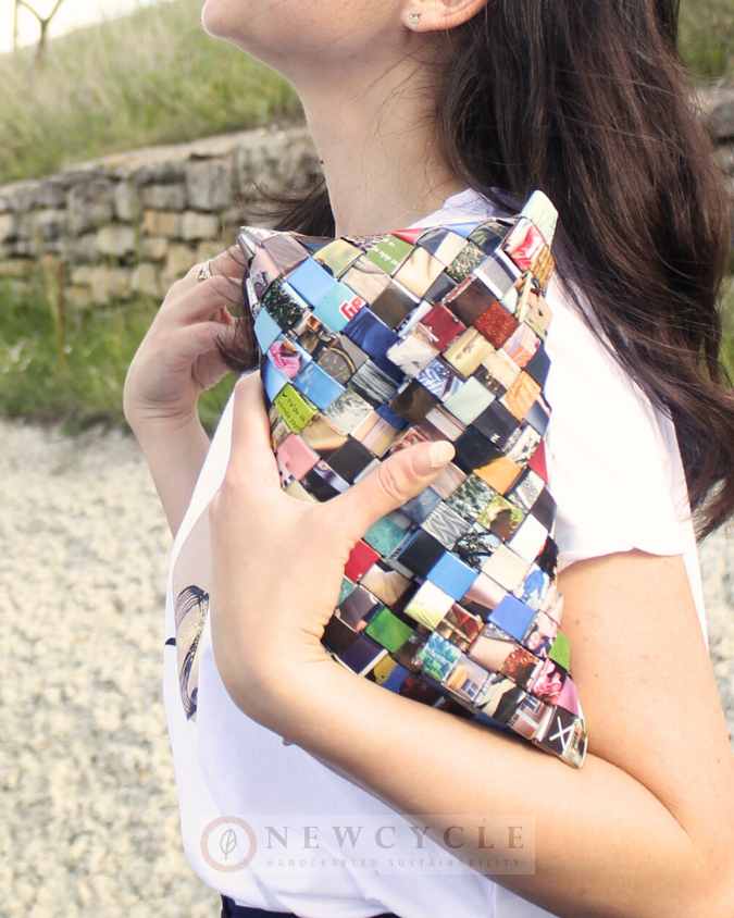 Woman holding a small multicolor woven eco purse