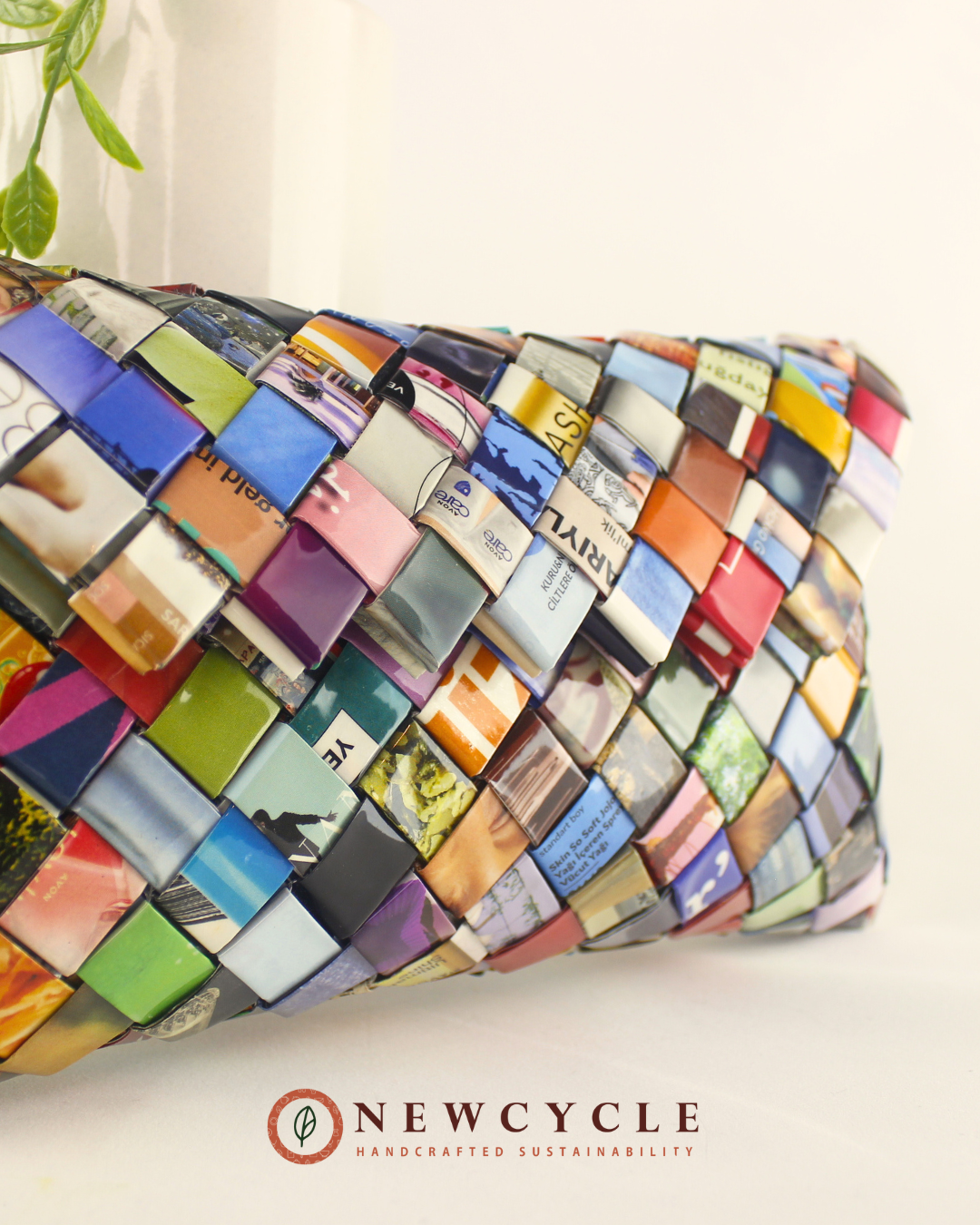 Flat-lay of multicolor woven clutch on white background