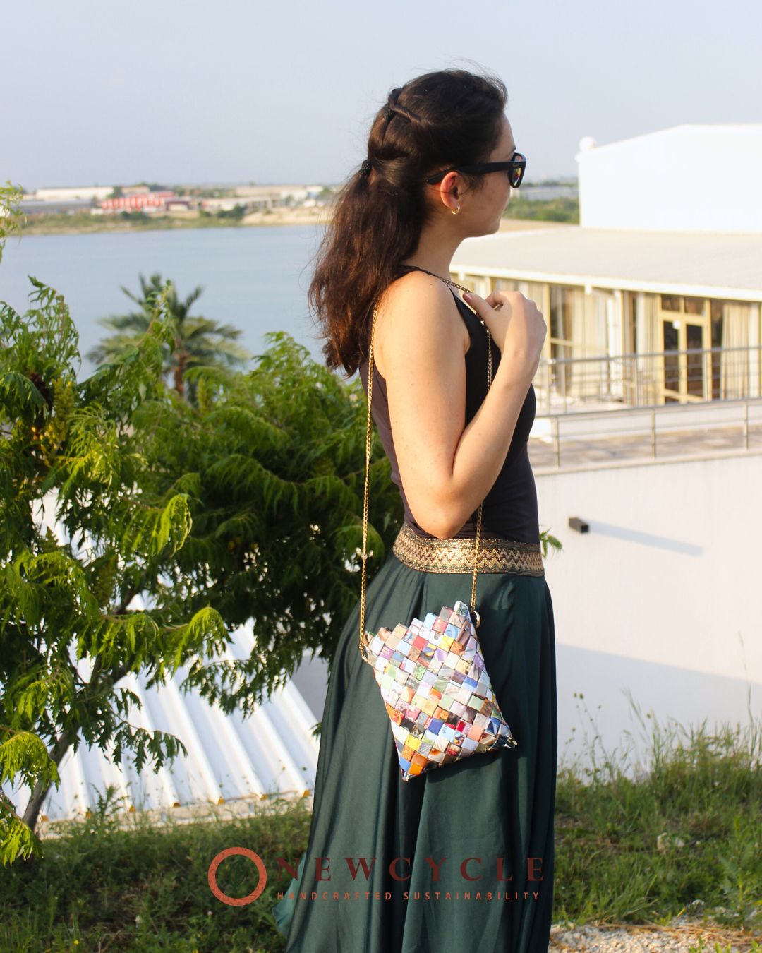 model wearing multicolor woven bag with chain strap