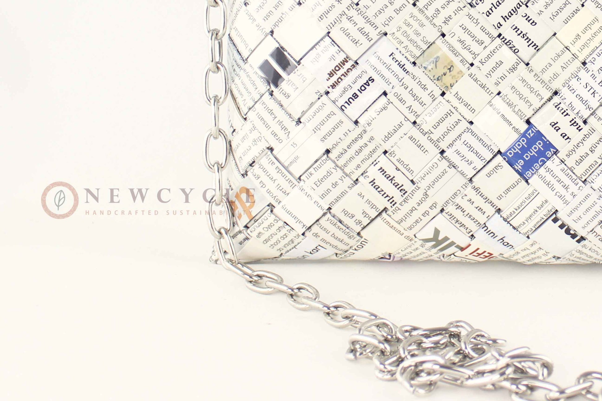 Close-up of newspaper-print hand-woven pattern on oversized bag