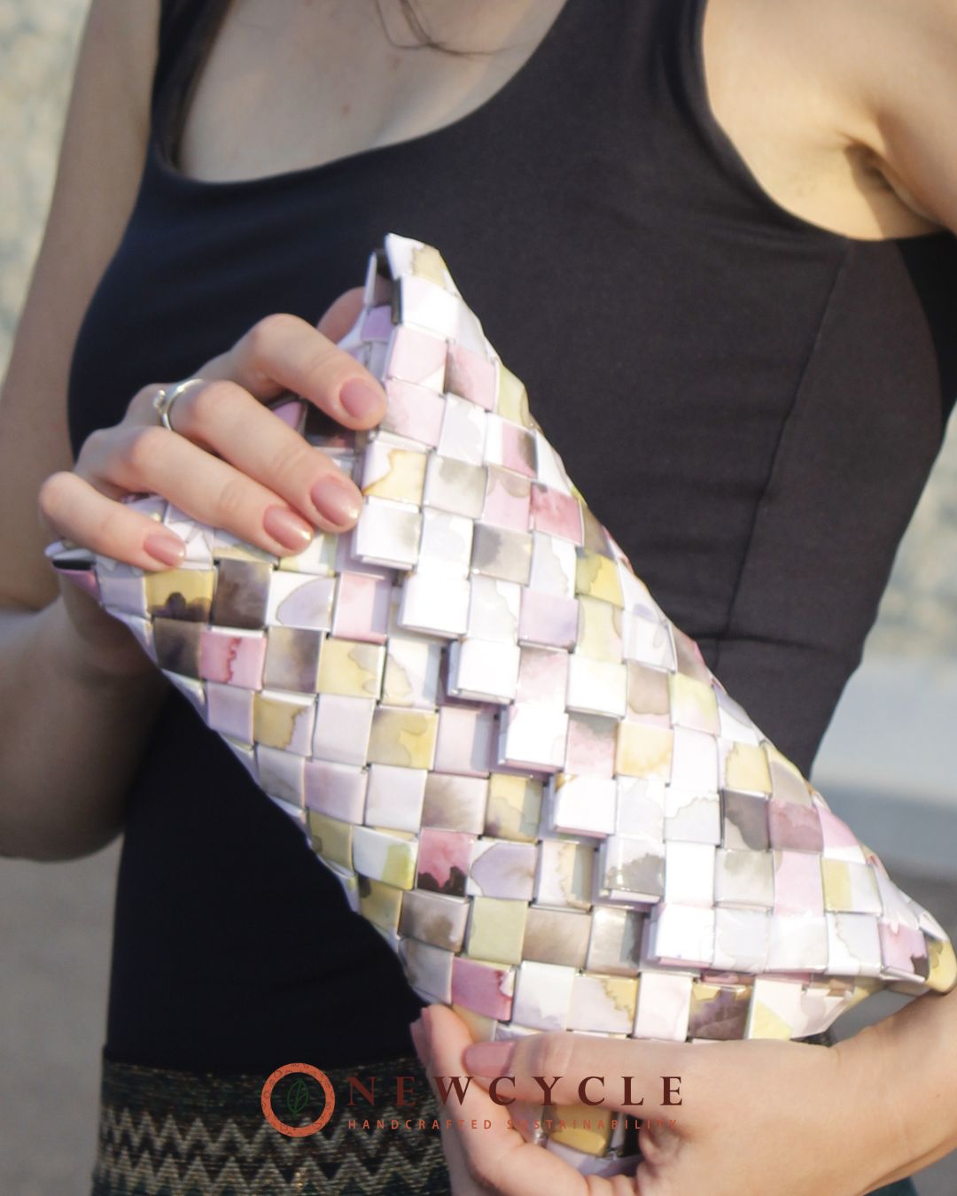 Pastel multicolor clutch bag styled on woman background