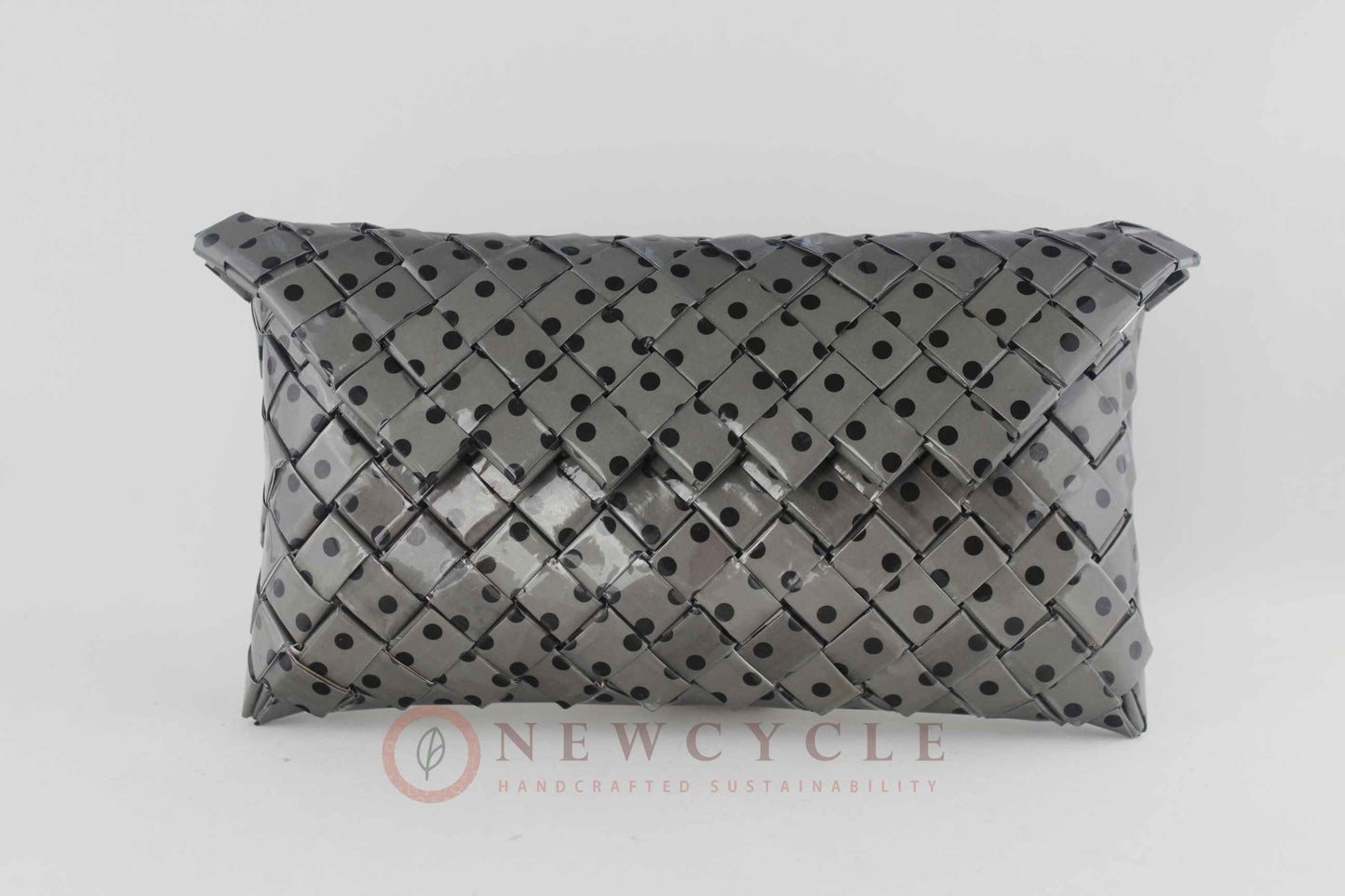 Front view of the black and grey polka-dot handmade woven clutch