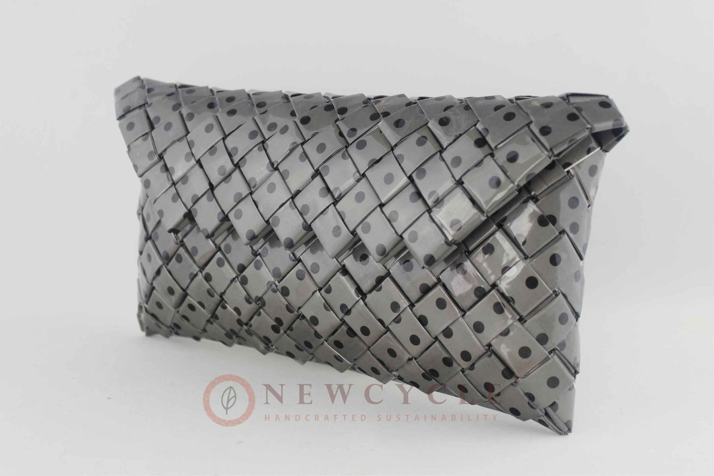 Back view of the black and grey polka-dot woven purse