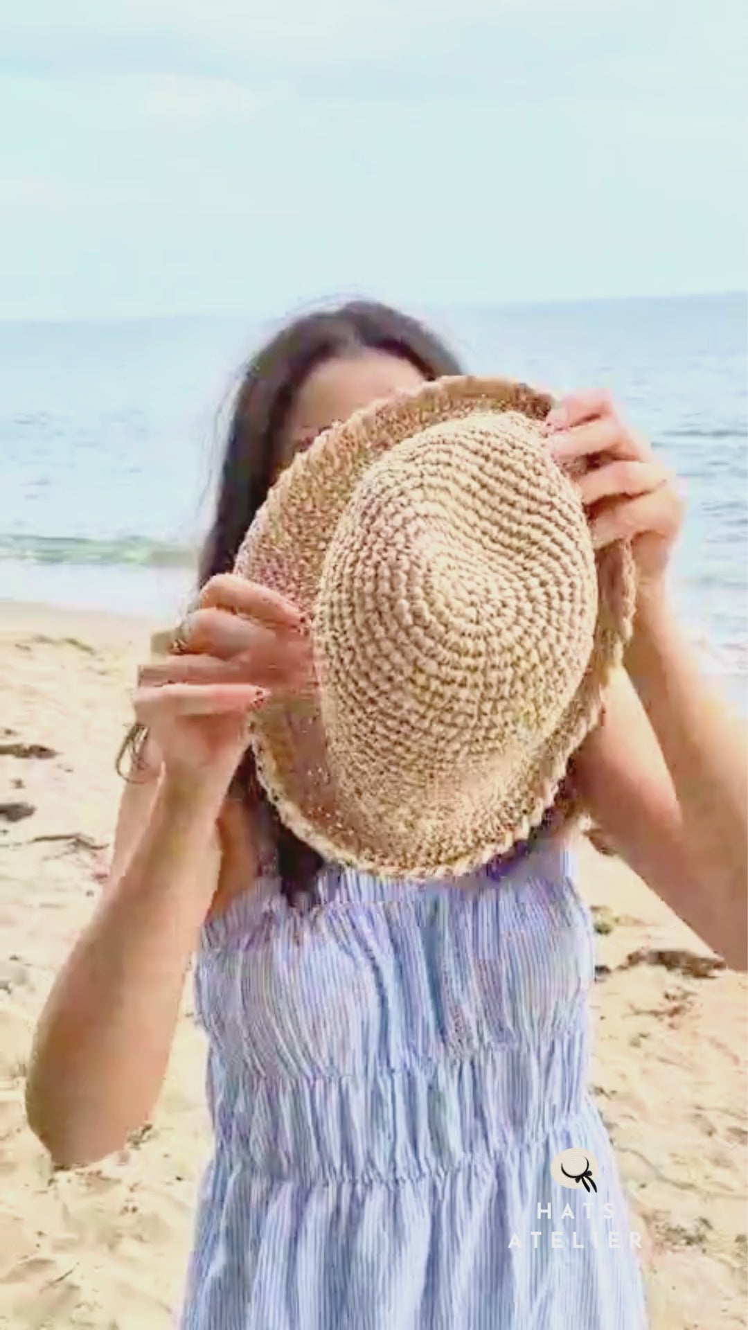 crochet raffia bucket hat worn at the beach as a lightweight summer straw hat