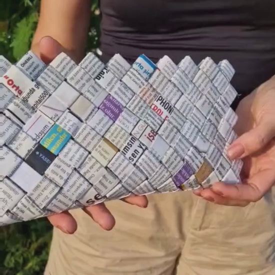 Woman wearing neutral outfit with white mosaic upcycled clutch, sustainable fashion accessory