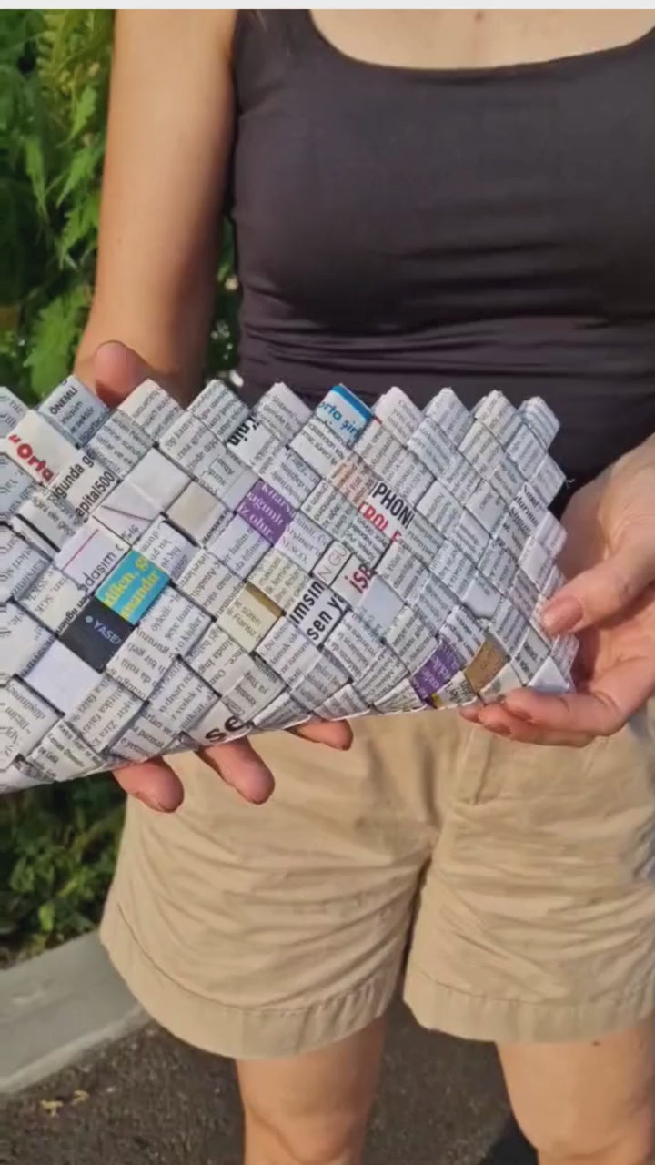 Woman wearing neutral outfit with white mosaic upcycled clutch, sustainable fashion accessory