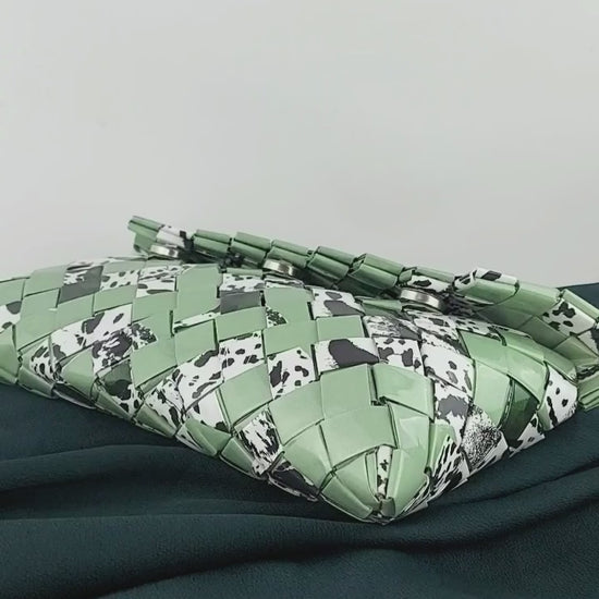 Video preview of green upcycled woven clutch with animal print