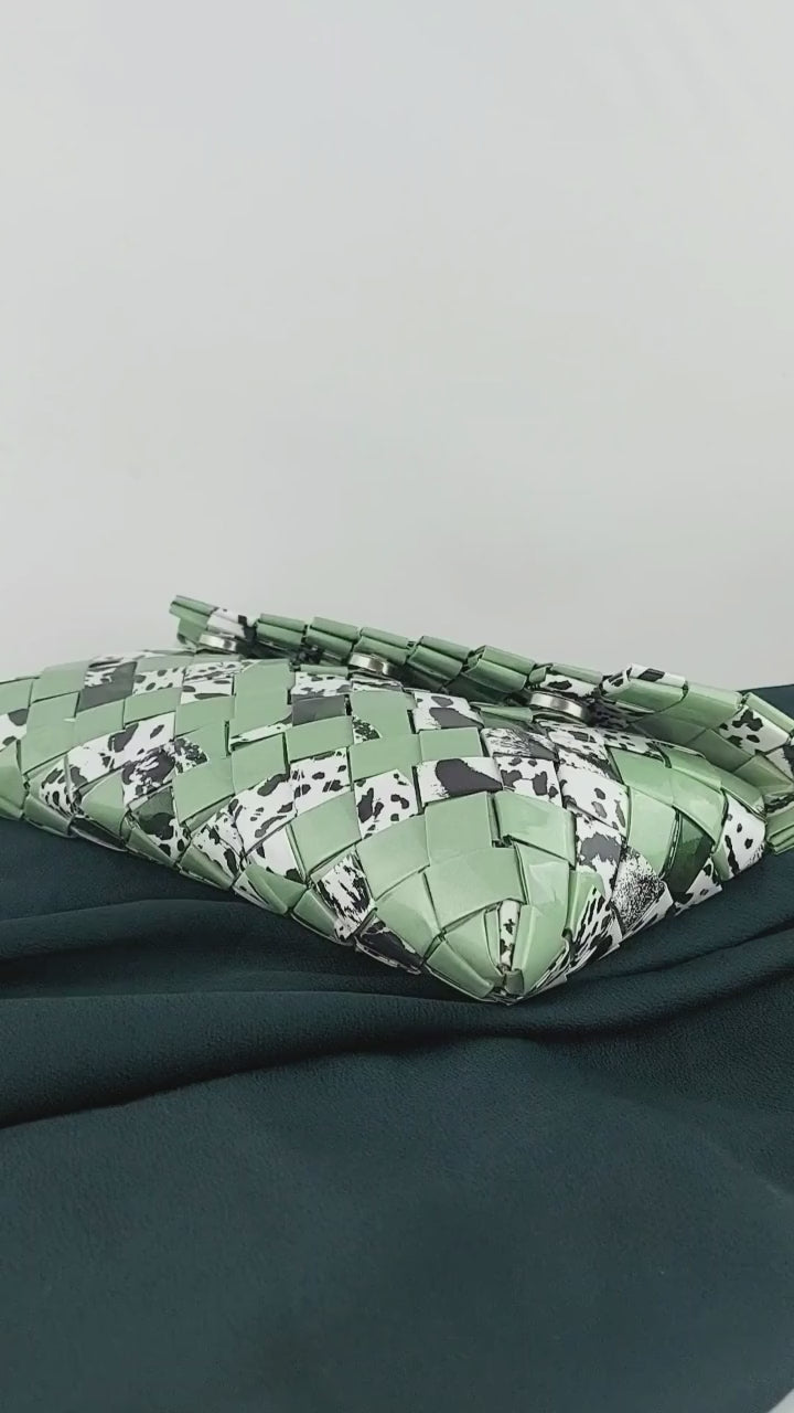 Video preview of green upcycled woven clutch with animal print