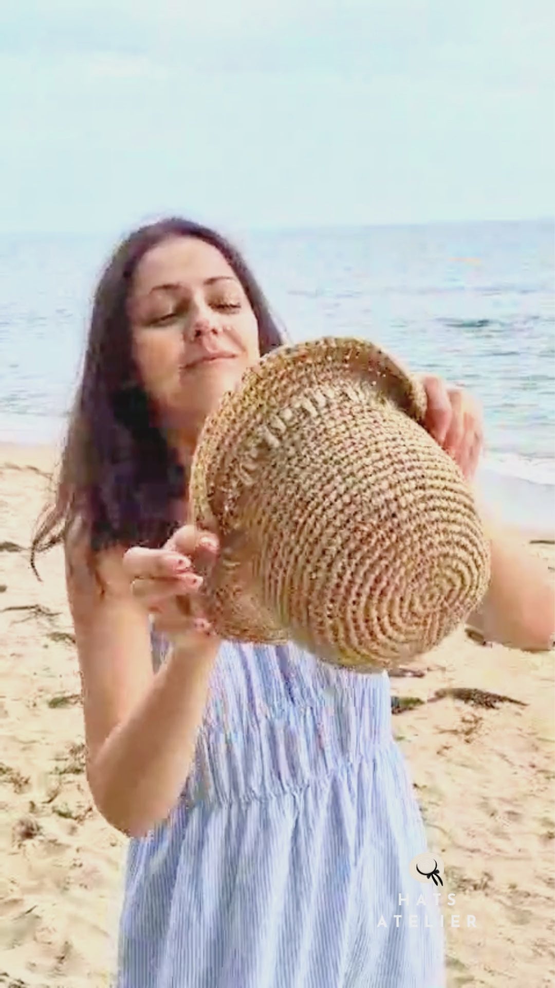 Short brim crochet raffia hat in natural straw shown in summer styling video