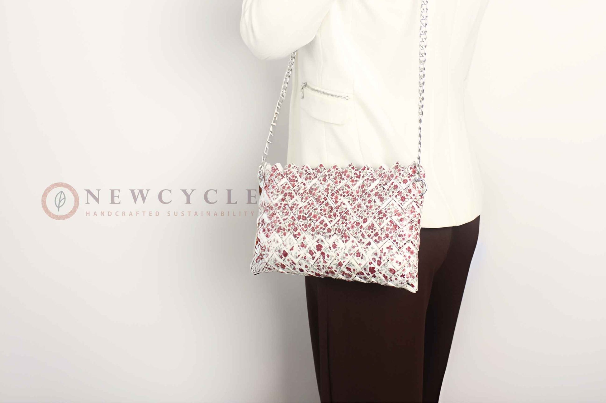 Red floral woven bag worn as an underarm shoulder purse