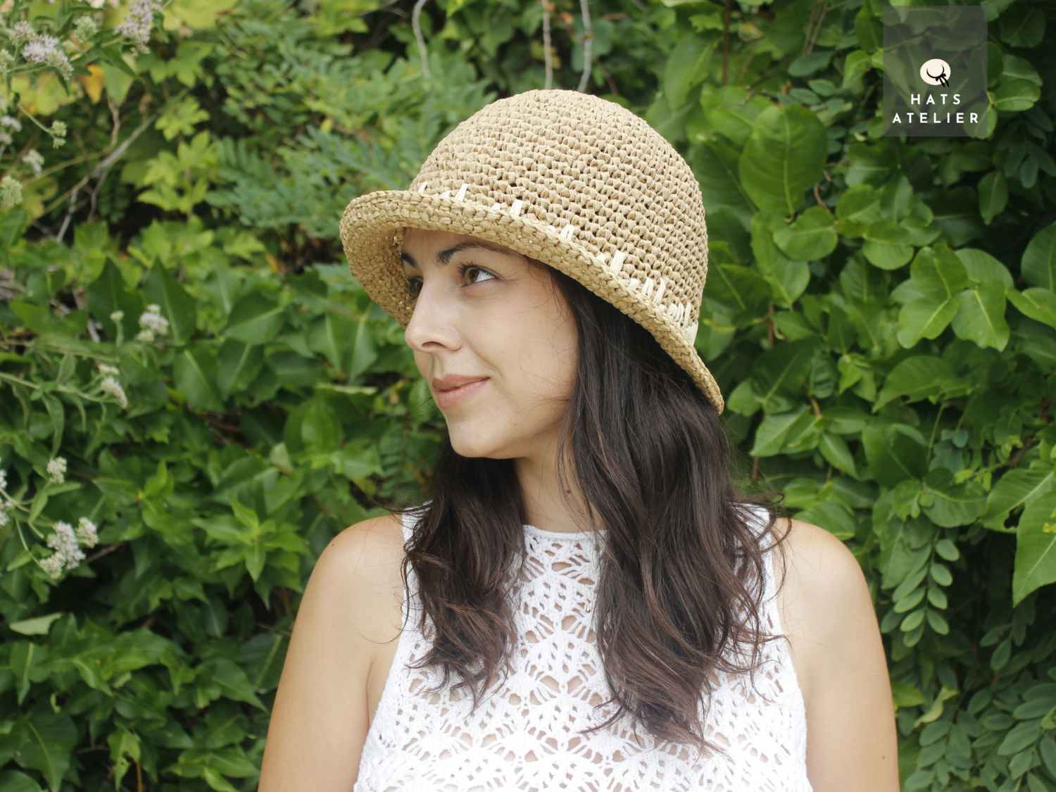 Handwoven short brim crochet raffia hat in natural straw, back view
