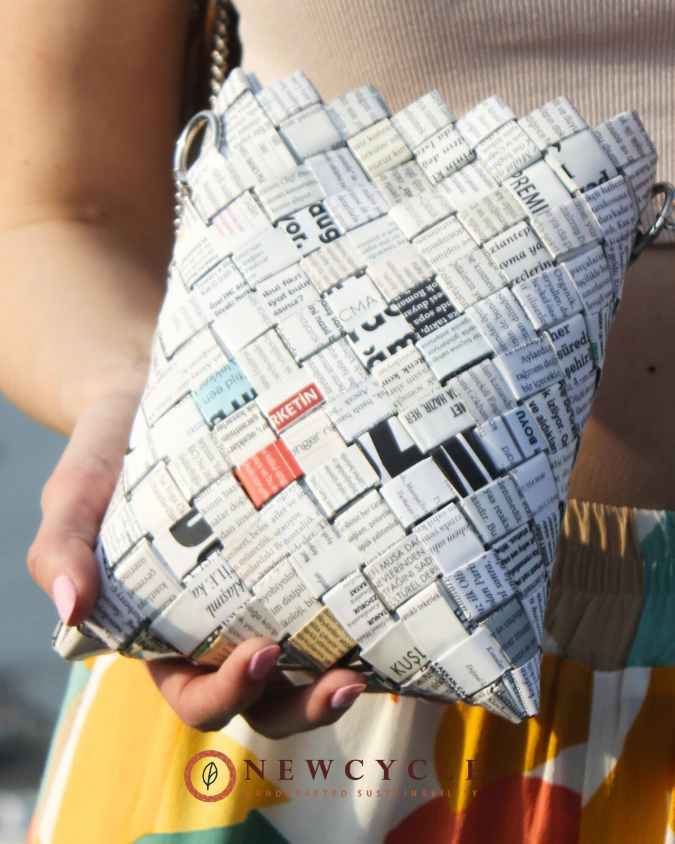 Close-up of handmade white newspaper woven purse – sustainable crossbody bag