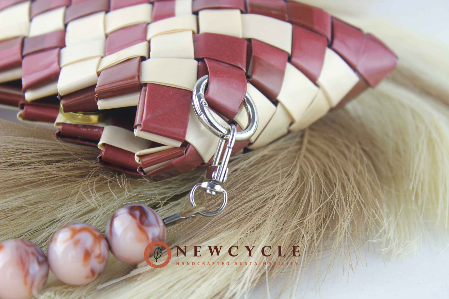 interior view of brown cream woven clutch with magnetic closure