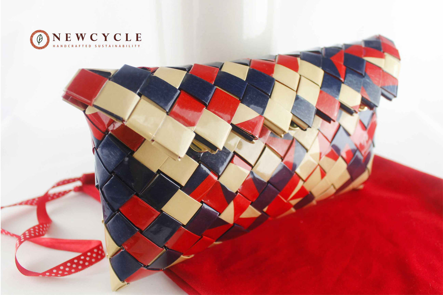 red navy cream woven clutch on red fabric