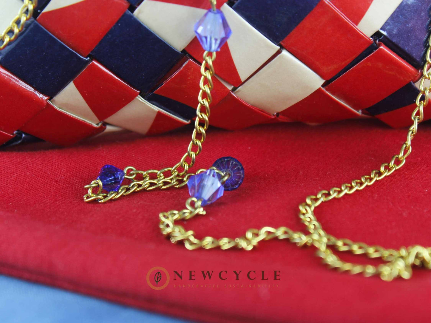 Side view of red navy beige handwoven crossbody bag with gold chain